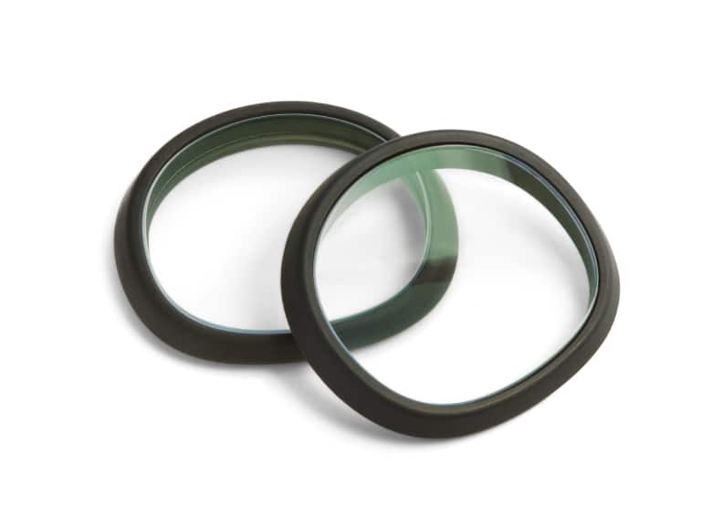 Two lens inserts for Meta Quest 3, one resting on top of the other. The lenses are clear and have a black border around the rim.